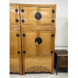 A Chinese elm cupboard or wardrobe in tw