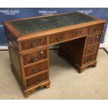 A reproduction mahogany kneehole desk, t