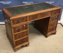 A reproduction mahogany kneehole desk, t