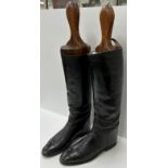 A pair of black leather hunting boots wi