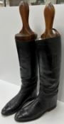 A pair of black leather hunting boots wi