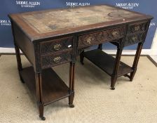 An Edwardian mahogany kneehole desk in t