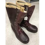 A pair of leather safety boots with rubb