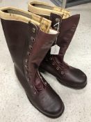 A pair of leather safety boots with rubb