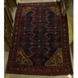 A Persian rug, the central panel set wit