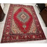 A Persian rug, the central panel set wit