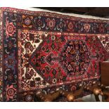 A Persian rug, the central panel set wit