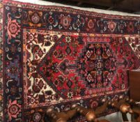 A Persian rug, the central panel set wit