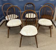 An Ercol elm rounded rectangular dining