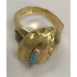 An 18-carat gold and turquoise set crossover ring, size J, 7.