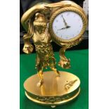 A 19th Century French gilt brass figural mantel clock as a robed maiden holding aloft a drum,