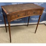 A modern reproduction two drawer side table with concave front and leather inset top,