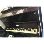 An early to mid 20th Century mahogany cased upright piano,