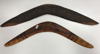 A vintage Australian native wooden boomerang carved with various bird figures and trees, 62 cm long,