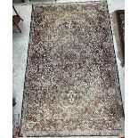 A Persian wool and silk rug, the central panel set with all-over floral decoration on a cream,