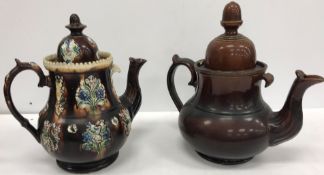 A collection of four treacle-glazed teapots including a 19th Century snuff taking Toby,