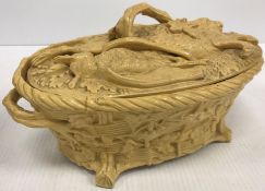 A 19th Century buff glazed game pie dish decorated in heavy relief with game to the lid and oak