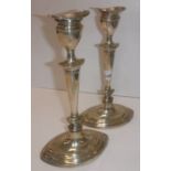 A pair of Edwardian silver table candlesticks of navette form with loaded bases (by Williams,