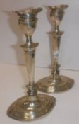 A pair of Edwardian silver table candlesticks of navette form with loaded bases (by Williams,