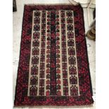 A Belouch rug, the central panel set with rows of repeating geometric design on a mushroom ground,