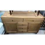 A Cort light oak dwarf sideboard with plain top over two long drawers and three central short