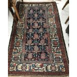 A Mahal rug, the central panel set with stylised hook motifs on a blue ground,