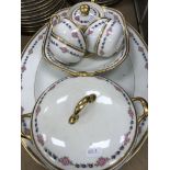 A Limoges porcelain dinner service comprising one large serving platter, two small serving dishes,