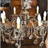 A French brass eight branch electrolier/chandelier with hanging lustre drops/crystal pendants 108