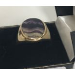 A 9 carat gold bluejohn set signet ring, the bluejohn as an oval roundel, size Z + 1,