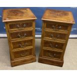 A pair of walnut dwarf chests in the Georgian style, the figured tops feathered,