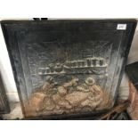 A cast iron fire back depicting figures in an ale house, 52 cm wide x 65 cm high,