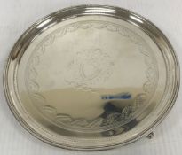 A Victorian silver card tray with engraved decoration and central shield motif,