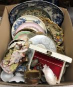 Three boxes of assorted china figurines, decorative plates,