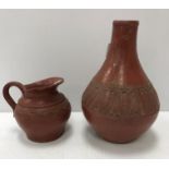 A Redware gourd shaped pottery vase with central band of foliage on a plain ground raised on a