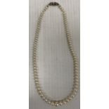 A single strand of Mikimoto graduated cultured pearls, bearing guarantee No.