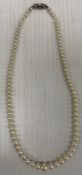 A single strand of Mikimoto graduated cultured pearls, bearing guarantee No.