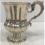 A Victorian silver tankard of waisted gourd stylised form with scrolling handle,