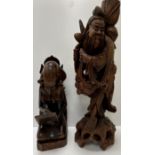 An Eastern carved hardwood figure of a bearded gentleman with staff and peaches 53.