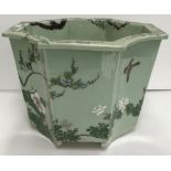 A celadon glazed jardiniere of octagonal tapering form with four curved sides,
