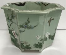A celadon glazed jardiniere of octagonal tapering form with four curved sides,