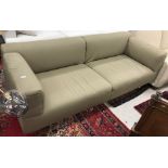 A B&B Italia olive green upholstered two seat sofa on tubular metal supports,