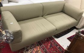 A B&B Italia olive green upholstered two seat sofa on tubular metal supports,