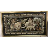 A 20th Century Indonesian embroidered and sequinned panel depicting "Two figures and elephants with