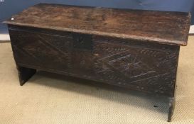 A circa 1700 oak hutch, the single piece top with moulded edge over a carved panelled front,