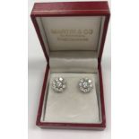 A pair of diamond ear studs, the centre stones approx. 0.3 carat, within eight 0.