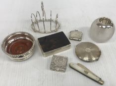 A collection of silver wares comprising silver four section toast rack of simple form,