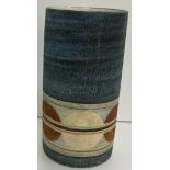 A Troika pottery cylindrical vase by Penny Black with circular decoration,