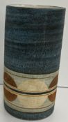 A Troika pottery cylindrical vase by Penny Black with circular decoration,