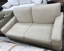 A modern fawn corduroy type upholstered two seat sofa on heavy square tapered supports,