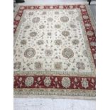 A Ziegler type carpet, the central panel set with scrolling foliate decoration on a cream ground,